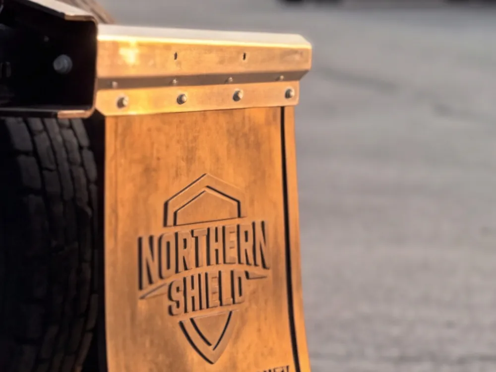Close-up detail of a branded truck mud flap logo
